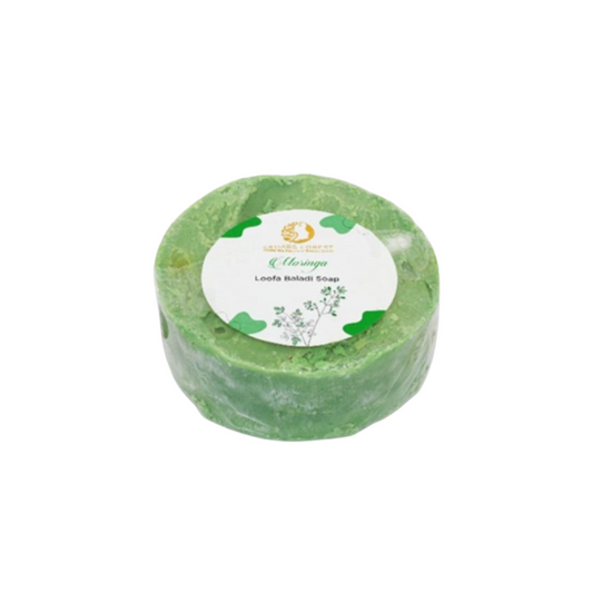 Get squeaky clean with the Moringa Loofa Baladi Soap! Made with natural moringa and a loofah, this soap exfoliates and nourishes the skin for a refreshing feel. Say goodbye to dull skin and hello to a radiant glow. Keep your skin happy and healthy with this quirky soap.